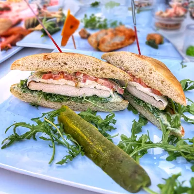 Ciabatta bread, pesto paste, chicken breast, mozzarella cheese, arugula, tomatoes