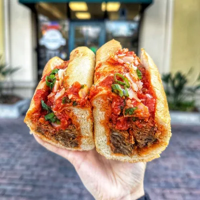 Rib-eye meatballs made in-house, house roasted garlic red sauce, topped with melted mozzarella on a toasted hoagie roll