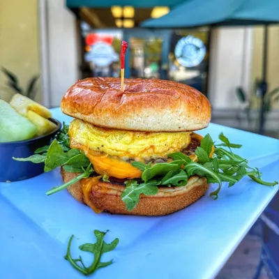 Brioche bun, garlic aioli, sausage, egg, Yellow cheddar cheese, arugula