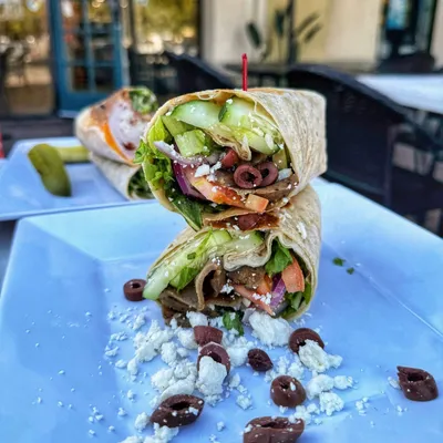 Flame broiled hand-carved Gyro with our house made tzatziki sauce, roma tomatoes, thinly sliced red onion, sliced cucumbers, feta cheese, kalamata olives, romaine lettuce in a flower tortilla.