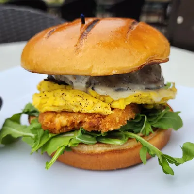 Brioche bun, large portobello sautéed mushroom, sunny-side up egg, provolone cheese, garlic aioli, arugula, hashbrown with a dash of maple syrup.