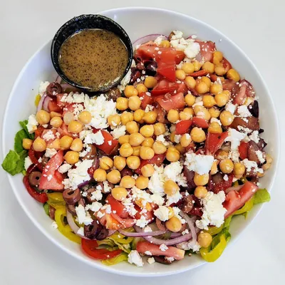 Crisp romaine, kalamata olives, red onions, chickpeas, roasted red bell peppers, cucumbers, Roma tomatoes, sliced yellow peppers, and feta cheese, served with our homemade dressing.
