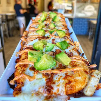 Chicken, mozzarella cheese, house chipotle sauce, red onions, avocado and bacon.