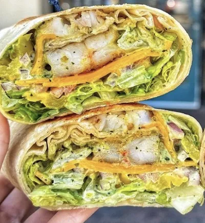 Jumbo shrimp marinated house garlic sauce, romaine lettuce, banana peppers, Roma tomatoes, vermont cheddar cheese and cilantro garlic house sauce wrapped in a fresh tortilla.