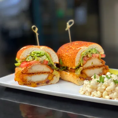 2 Japanese Panko-battered antibiotic-free chicken breasts, thick-cut bacon, Vermont cheddar cheese, sliced avocado, shredded Romaine lettuce, chopped jalapeños, Roma tomatoes on a toasted Dutch crunch roll.