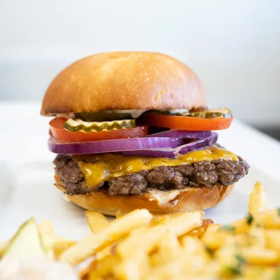 Brioche bun, peppercorn aioli, hand-patted ribeye, American cheddar, arugula, red onions, tomatoes, pickles